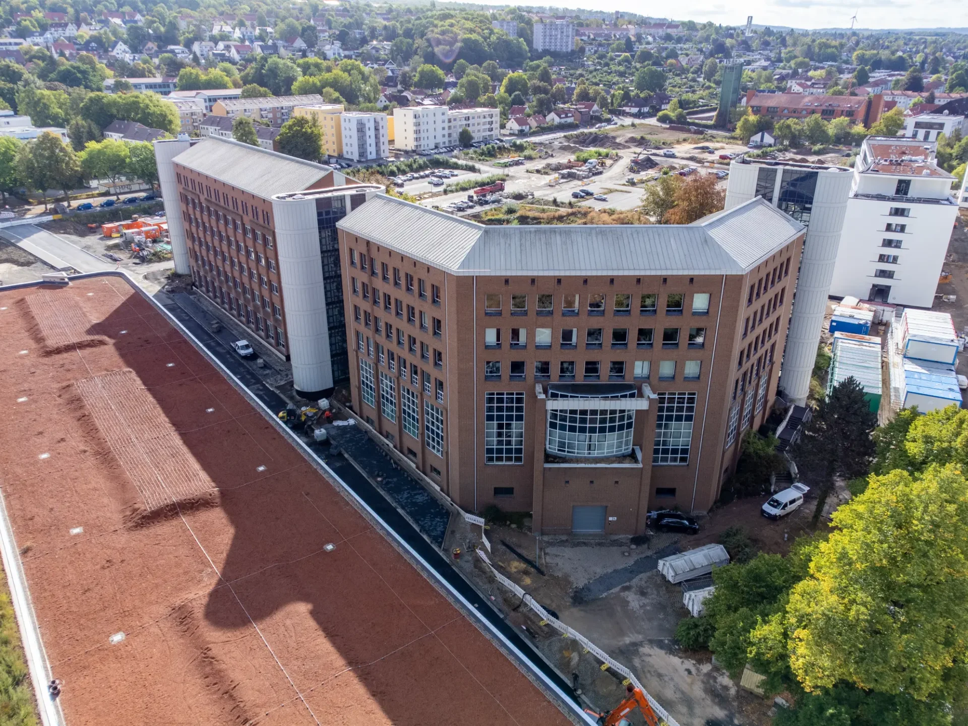 A Building With Many Windows And A Parking Lot